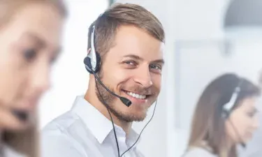 IT Associate Speaking on Headset with Customer